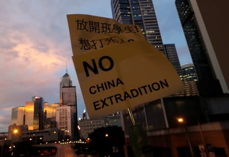 A placard is displayed during a protest following a day of violence over a proposed extradition bill, near the Legislative Council building in Hong Kong