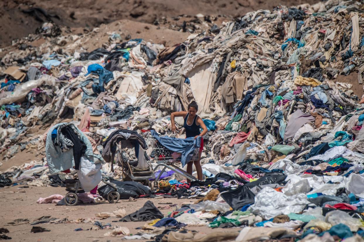 A woman searches for clothes in the Chilean Desert.