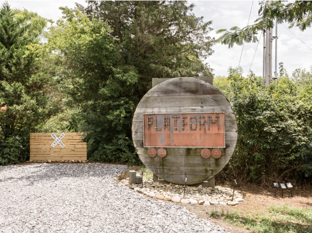 A hand-made “Platform 1346” train sign is made of wood that had been stored in the train car. Photo credit: Airbnb.