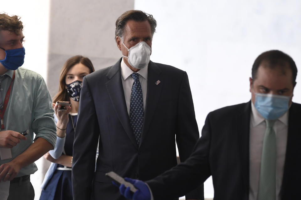 Sen. Mitt Romney, R-Utah, talks to reporters as he arrives for the weekly Republican policy luncheon on Capitol Hill in Washington, Tuesday, June 9, 2020. (AP Photo/Susan Walsh)