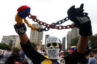 A demonstrator wears a mask reading: 'Resists Venezuela, Maduro murderer, dictator' while rallying against Venezuela's President Nicolas Maduro in Caracas, Venezuela May 1, 2017. REUTERS/Carlos Garcia Rawlins