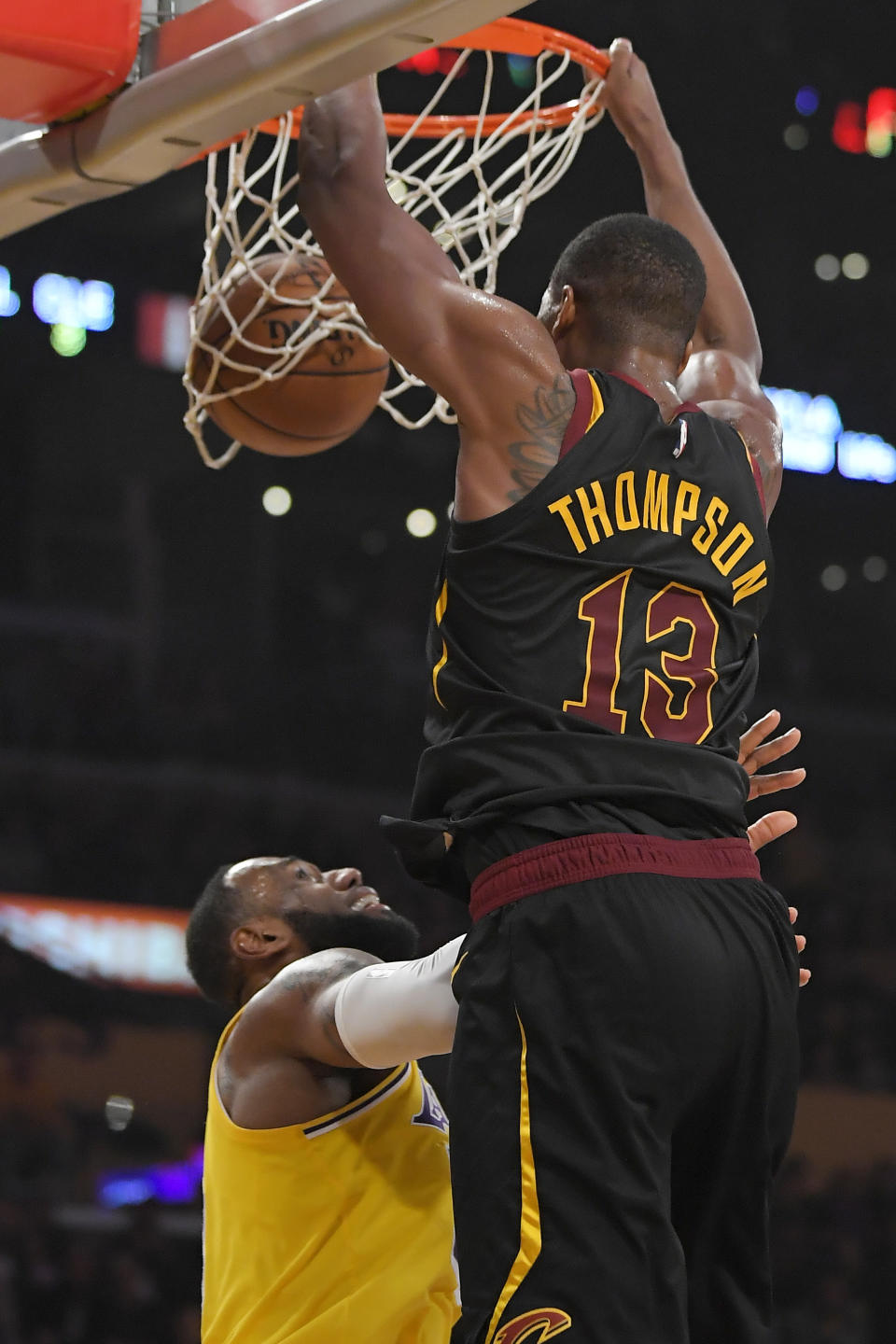Cleveland Cavaliers center Tristan Thompson, right, dunks over Los Angeles Lakers forward LeBron James during the first half of an NBA basketball game Monday, Jan. 13, 2020, in Los Angeles. (AP Photo/Mark J. Terrill)