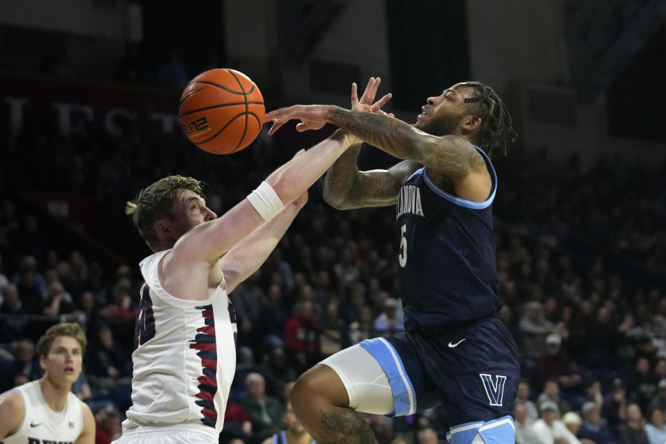 Villanova's Justin Moore, right, cannot get a shot past Pennsylvania's George Smith during the first half of an NCAA college basketball game, Monday, Nov. 13, 2023, in Philadelphia. (AP Photo/Matt Slocum)