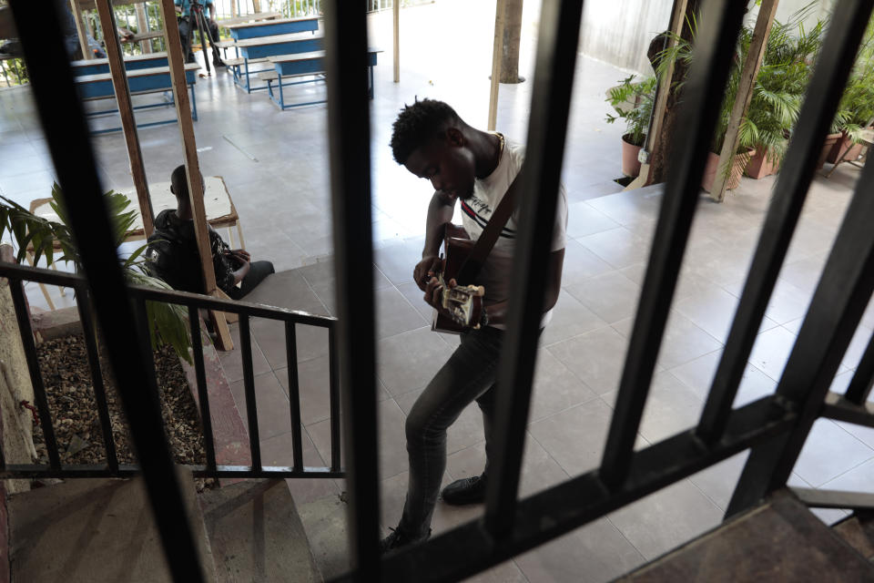A student practices guitar at the Plezi Mizik Composition Futures School in Port-au-Prince, Haiti, Thursday, Sept. 21, 2023. Students meet twice a week to play for two hours. (AP Photo/Odelyn Joseph)