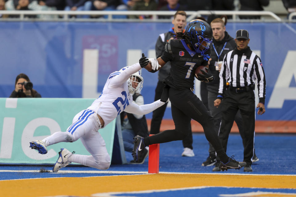 Boise State wide receiver Latrell Caples (7) crosses the goal line for a touchdown as BYU defensive back Talan Alfrey (25) tries to knock him out of bounds in the first half of an NCAA college football game, Saturday, Nov. 5, 2022, in Boise, Idaho. (AP Photo/Steve Conner)