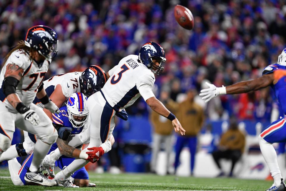 Broncos quarterback Russell Wilson passes as he is tackled by the Bills' AJ Epenesa during the second half of Denver's 24-22 upset win Monday night in Orchard Park, N.Y.