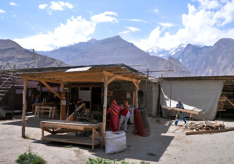 Local carpenters work at their woodshop in Altit village, in Pakistan's northern Hunza valley, on August 6, 2014