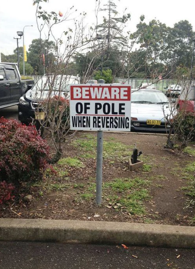 A sign in a parking lot that reads, 