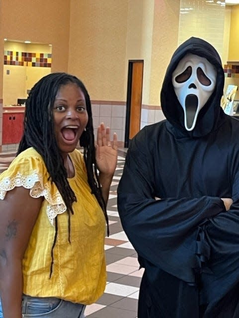 Erica Van Buren, Fort Myers News-Press and Naples Daily News reporter, with Ghostface, a character best known from the Scream movie franchise at Regal Gulf Coast in Fort Myers.