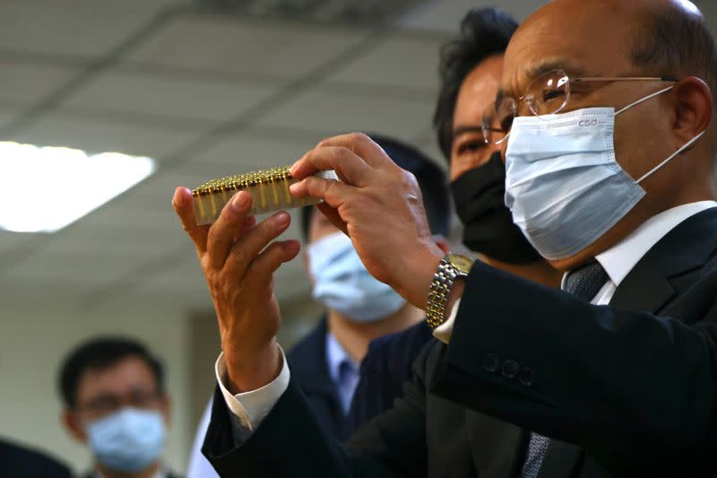 Premier Su Tseng-chang of Taiwan's Executive Yuan studies bullets while attending a news conference unveiling the largest smuggling bullet case in the history of Taiwan in Taipei