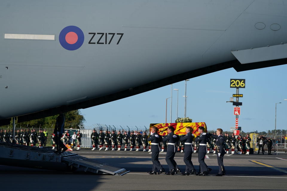 The coffin of Queen Elizabeth II is carried to the RAF aircraft at Edinburgh Airport, Scotland, Tuesday Sept. 13, 2022, for the final journey from Scotland in a Royal Air Force plane to London. (Andrew Milligan/Pool via AP)