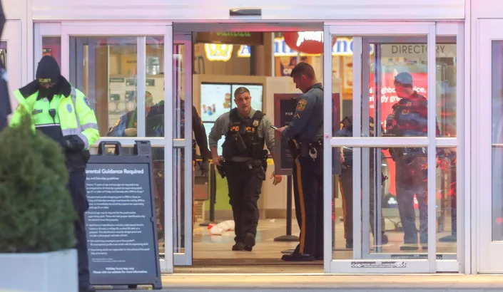 Police, fire and medical personnel respond in force to the food court entrance at the Christiana Mall after a shooting Saturday evening, April 8, 2023. 