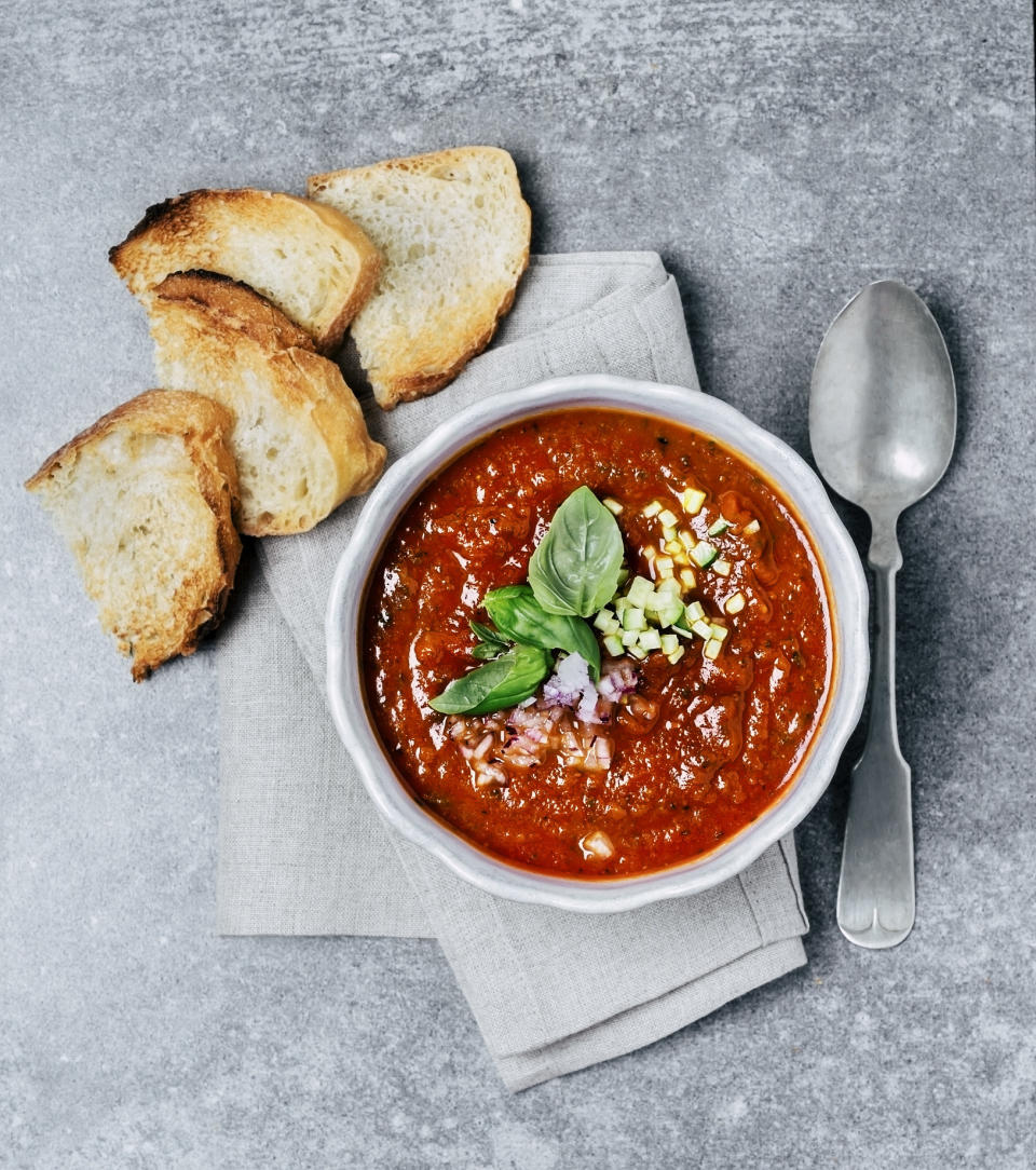 Tomato soup with sliced bread on the side.