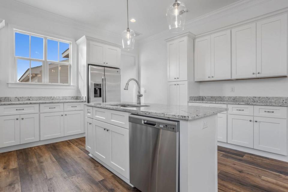 A bright and white kitchen with a patio nearby, makes this home ideal for entertaining. It was built at The Village at Tradition by Tootle Homes.