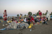 Tigray refugees who fled the conflict in the Ethiopia's Tigray sit up after waking up early in the morning at Hamdeyat Transition Center near the Sudan-Ethiopia border, eastern Sudan, Thursday, Dec. 3, 2020. Ethiopian forces on Thursday blocked people from the country's embattled Tigray region from crossing into Sudan at the busiest crossing point for refugees, Sudanese forces said.(AP Photo/Nariman El-Mofty)