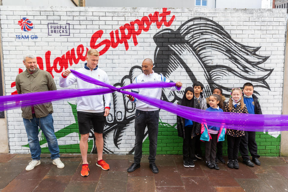 Jackson unveils the Purplebricks Home Support mural in Cardiff alongside rugby sevens star Sam Cross, pupils from Ninian Park Primary School and the mural artist Bradley Woods