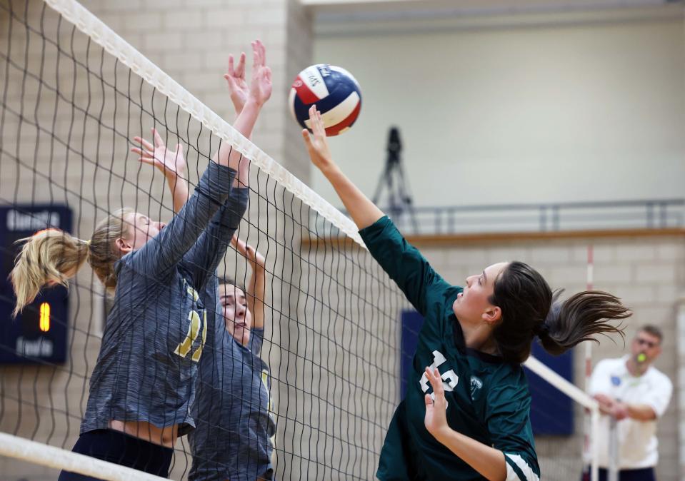 Abington's Brenna O'Brien spikes the volleyball over East Bridgewater's Caitlyn Gallagher during a game on Wednesday, Oct. 13, 2022.