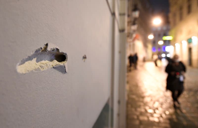 Person walks near the site of a gun attack in Vienna