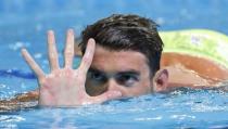 Jun 29, 2016; Omaha, NE, USA; Michael Phelps holds up five fingers during the finals for the men's 200 meter butterfly in the U.S. Olympic swimming team trials at CenturyLink Center. Erich Schlegel-USA TODAY Sports