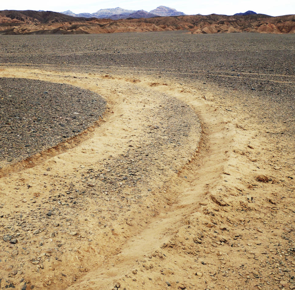 This January, 2019 photo provided by the U.S. National Park Service shows vehicle tracks in an area of Death Valley National Park, Calif., that park staff says can leave a lasting trench. National parks across the United States are scrambling to clean up and repair damage caused by visitors and storms during the government shutdown while bracing for another possible closure ahead of the usually busy President's Day weekend. (National Park Service via AP)