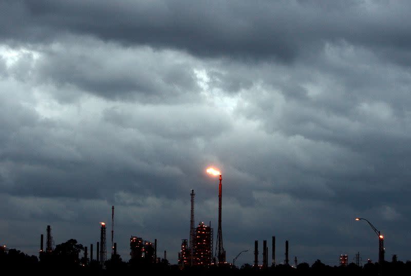 FILE PHOTO: Dark clouds are seen above a refinery as Hurricane Ike approaches the Gulf of Mexico near Houston, Texas