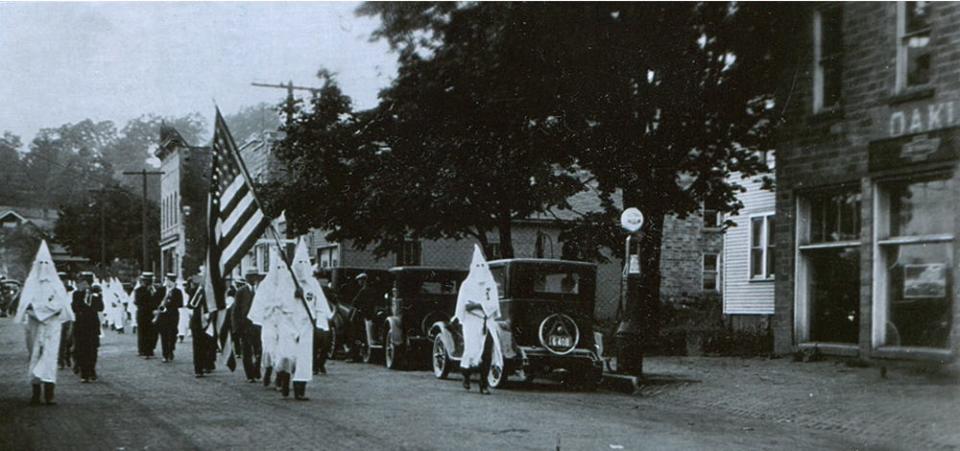 Hooded Klansmen march through Oakland in this 1925 image.