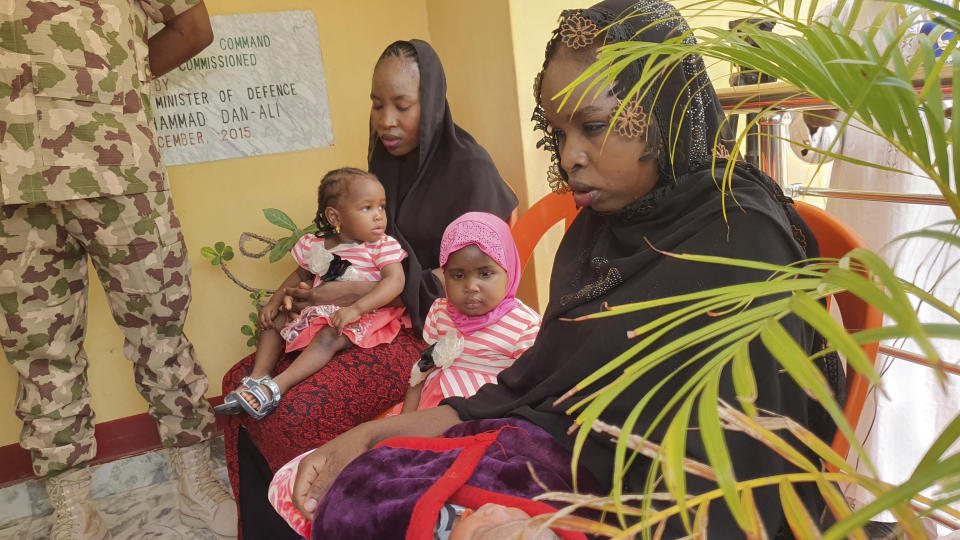 FILE- Then-recently freed Chibok schoolgirls sit with their children at the Army Maimalari Cantonment in Maiduguri, Nigeria, Thursday, May 4, 2023. Their experience represents a worrying new development in Nigeria, Africa's most populous country where the mass abduction of Chibok schoolgirls a decade ago marked a new era of fear even as nearly 100 of the girls remain in captivity. An array of armed groups now focus on abducting schoolchildren, seeing in them a lucrative way to fund other crimes and control villages in the nation's mineral-rich but poorly-policed northwestern region. (AP Photo/Jossy Ola, File)