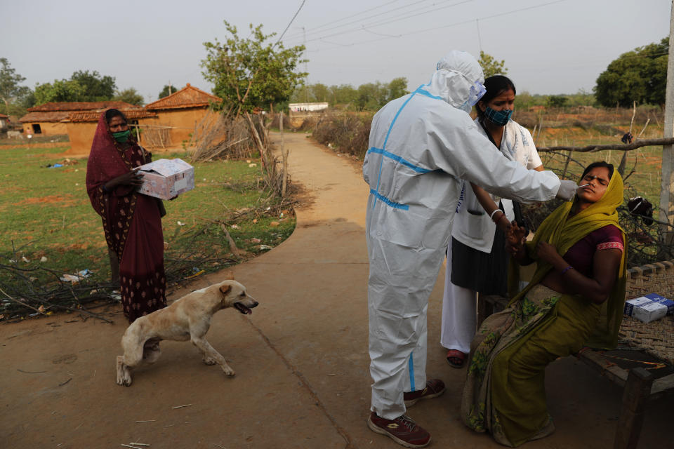 Health workers Neeraj, third right, and Aradhna take nasal sample of a woman for COVID-19 test at Jamsoti Village, in Chandauli district, Uttar Pradesh state, India, on June 8, 2021. India's vaccination efforts are being undermined by widespread hesitancy and fear of the jabs, fueled by misinformation and mistrust. That's especially true in rural India, where two-thirds of the country’s nearly 1.4 billion people live. (AP Photo/Rajesh Kumar Singh)