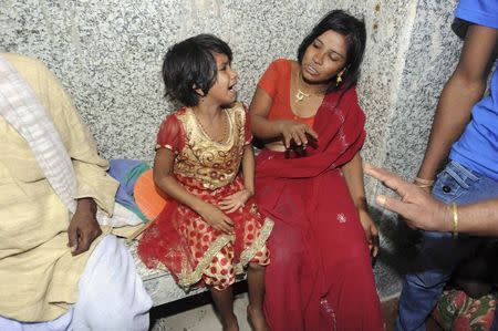 A girl and a woman cry outside an emergency hospital ward after their relatives were injured during a stampede in Patna October 3, 2014. REUTERS/Stringer