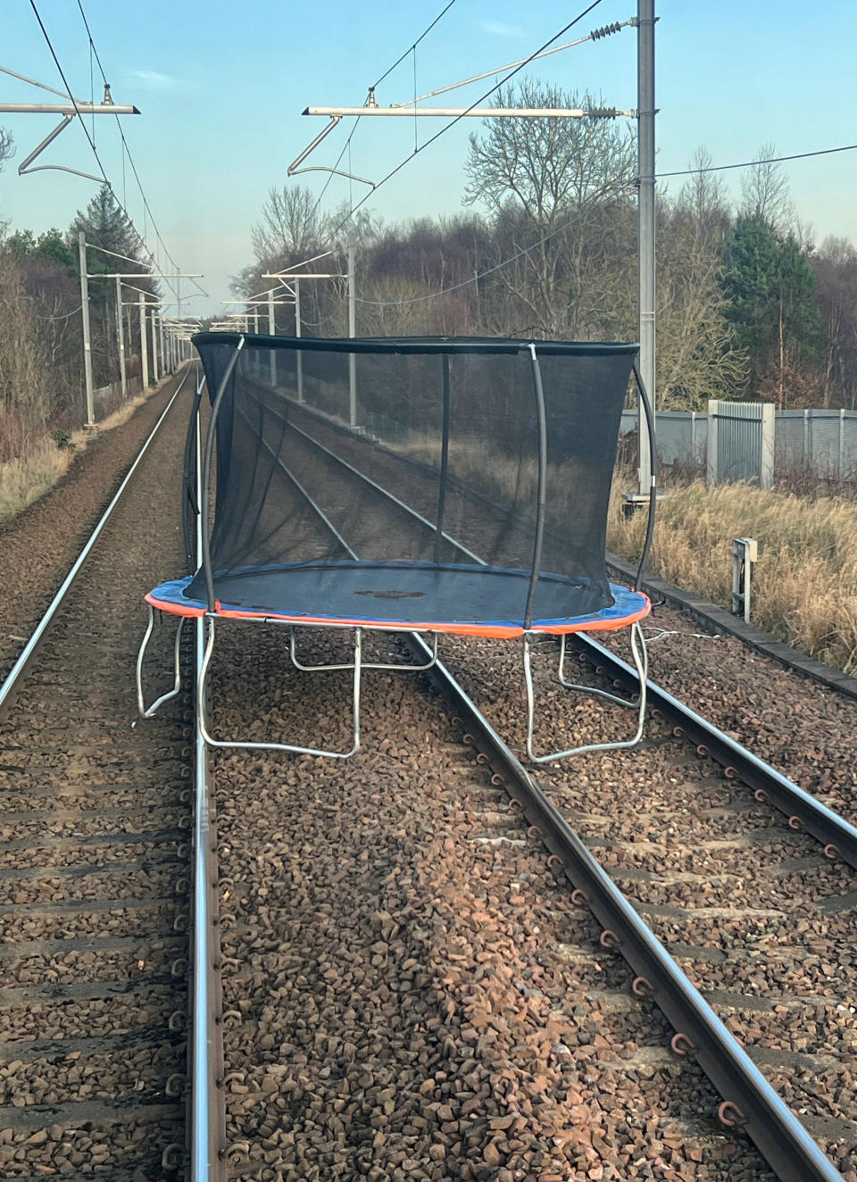Handout photo issued by Network Rail of a 10ft trampoline which was blown onto the main line between Glasgow Central and  Edinburgh via Shotts line, between West Calder and Livingston South stations during Storm Pia, landing the right way up. The line was closed at 14:49, and the trampoline was removed within an hour. Services restarted just after 1600. There were delays to ScotRail and DRS services during the incident. Picture date: Thursday December 21, 2023. PA Photo. See PA story WEATHER Wind. Photo credit should read: Network Rail/PA Wire 

NOTE TO EDITORS: This handout photo may only be used in for editorial reporting purposes for the contemporaneous illustration of events, things or the people in the image or facts mentioned in the caption. Reuse of the picture may require further permission from the copyright holder.