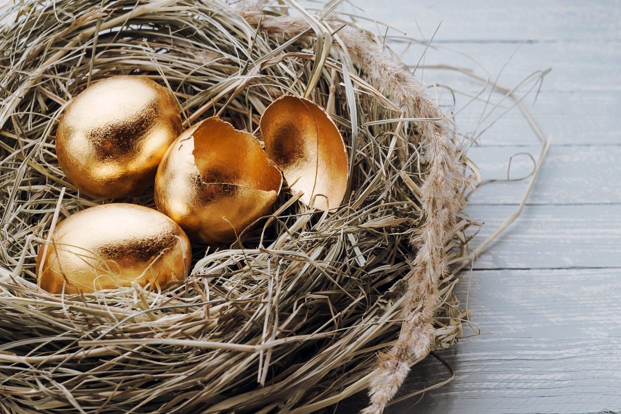 golden eggs in nest, one cracked