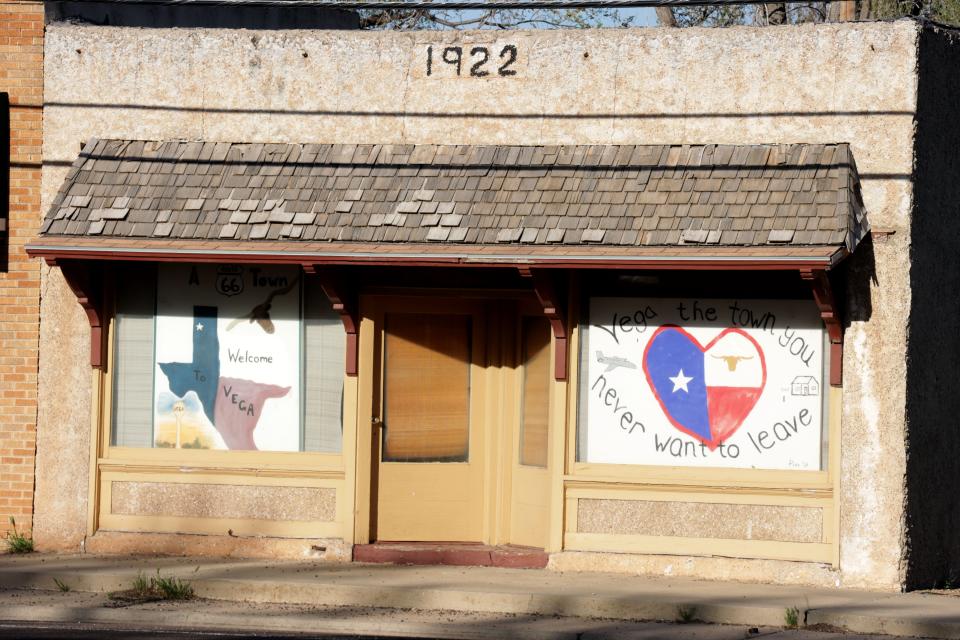 Signs in the window of a Vega, TX business. Some businesses closed in mid-March after the pandemic hit. The town's several restaurants started doing takeout only. The grocery store locked its doors and began doing pick up or delivery only.