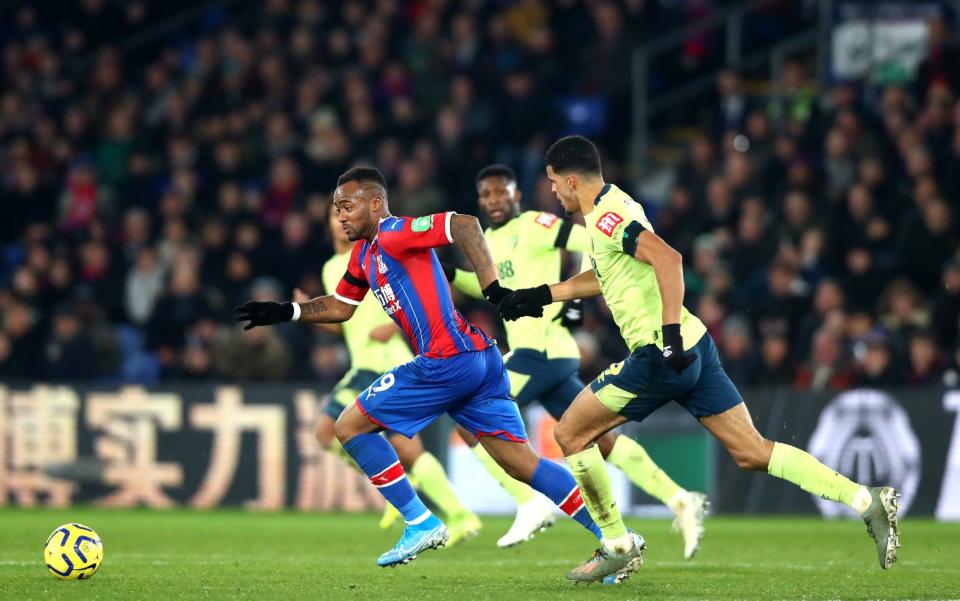 Jordan Ayew of Crystal Palace and Dominic Solanke of AFC Bournemouth challenges se the ball during the Premier League match between Crystal Palace and AFC Bournemouth - Getty Images