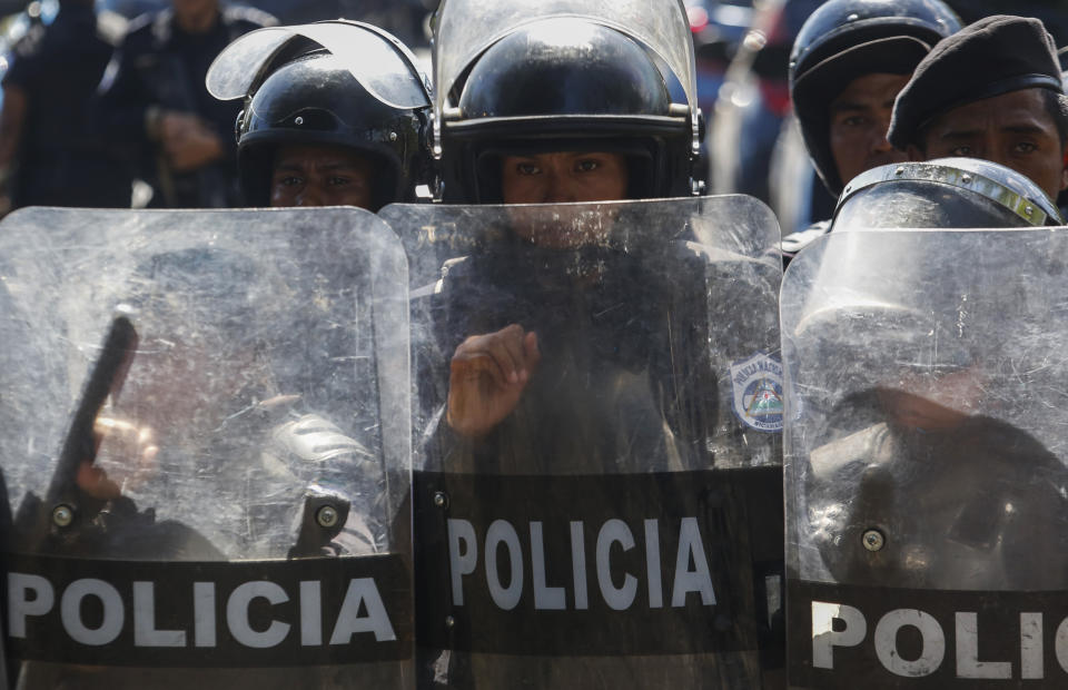 Police block anti-government protesters from marching in Managua, Nicaragua, Wednesday, April 17, 2019. Police prevented the march to commemorate a year since Nicaraguan protesters took to the streets to oppose the government of President Daniel Ortega. (AP Photo/Alfredo Zuniga)