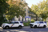 FILE - Police vehicles are parked at Roxborough High School near where multiple people were shot in Philadelphia, Wednesday, Sept. 28, 2022. On Monday, Oct. 23, 2023, federal authorities announced the arrest of the fifth and final suspect wanted in an ambush shooting that killed a 14-year-old and wounded several other teenagers outside the high school after a football scrimmage. (AP Photo/Matt Rourke, File)