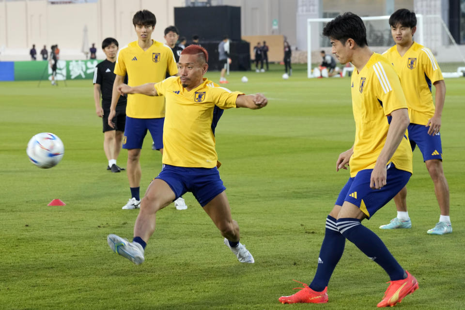 Japan's Yuto Nagatomo, left, and his teammates warm up during Japan official training on the eve of the group E World Cup soccer match between Japan and Germany, in Doha, Qatar, Tuesday, Nov. 22, 2022. (AP Photo/Eugene Hoshiko)