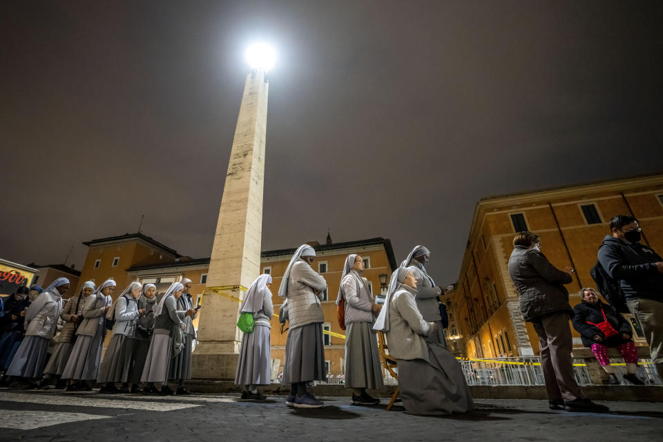 Nuns queue before dawn to view the body of Pope Emeritus Benedict XVI as it lies in state in St. Peter's Basilica at the Vatican, Tuesday, Jan. 3, 2023. The Vatican announced that Pope Benedict died on Dec. 31, 2022, at 95, and that his funeral will be held on Thursday, Jan. 5, 2023. (AP Photo/Ben Curtis)