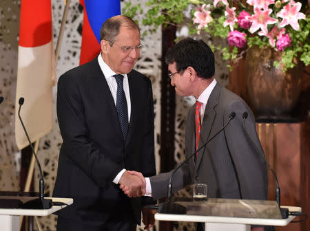 Russian Foreign Minister Sergei Lavrov shakes hands with Japanese Foreign Minister Taro Kono during their joint news conference after their two-plus-two Foreign and Defense Ministers meeting between Japan and Russia at the Iikura Guest House in Tokyo, Japan, May 30, 2019. Kazuhiro Nogi/Pool via Reuters