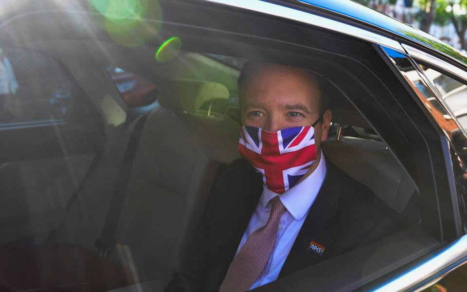 Wearing a Union Flag face mask, the Health Secretary is driven away to Westminster - Toby Melville/Reuters