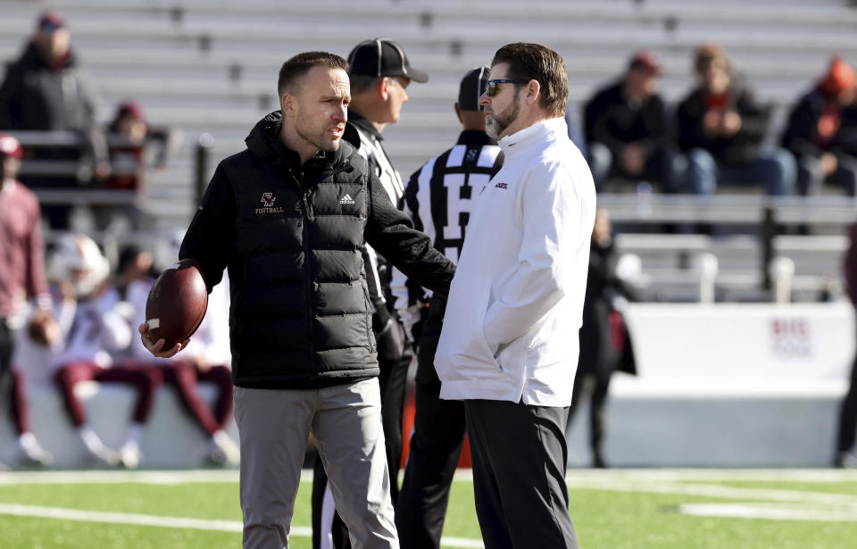 Boston College head coach Jeff Hafley, left, and VIrginia Tech head coach Brent Pry speak to each other before an NCAA college football game Saturday, Nov. 11, 2023 in Boston. (AP Photo/Mark Stockwell)