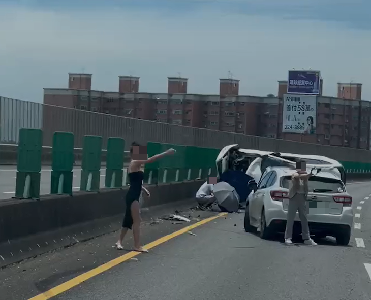 國道今日發生一起翻車事故，有女子在路旁揮手示警。翻攝畫面