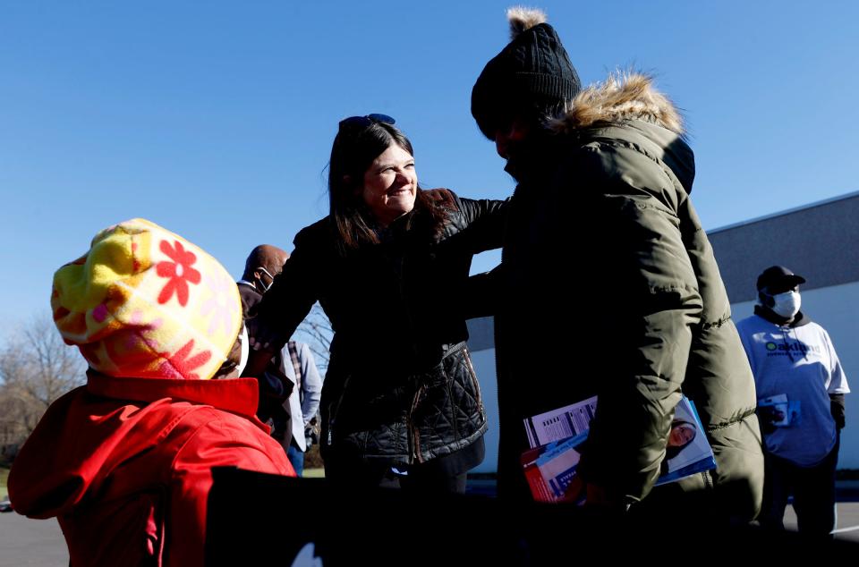 Rep. Haley Stevens, running for re-election has fun talking with volunteers handing out political literature (L to R) Cheryl McCarty, 63 and Lanelle McClain, 66, both of Pontiac outside of the Bowen Center where precincts four, five and six are in Pontiac on Election Day on Tuesday, Nov 8, 2022.