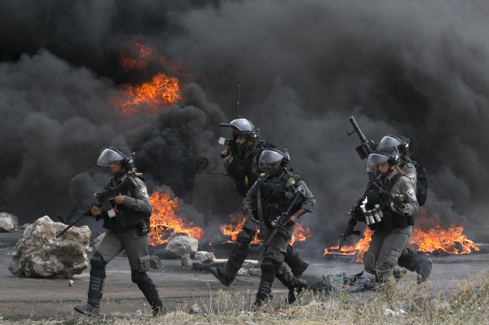 <p>Palestinians clash with Israeli security forces after a protest marking Nakba, or “catastrophe”, commemorating the more than 700,000 Palestinians who fled or were expelled in the 1948 war surrounding Israel’s creation, and against the US’ relocation of its embassy from Tel Aviv to Jerusalem, at the Hawara checkpoint south of Nablus on May 15, 2018. (Photo: Jaafar Ashtiyeh/ AFP/Getty Images) </p>