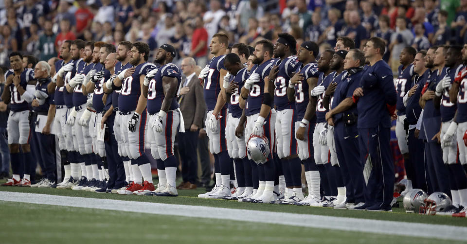 New England Patriots players stand for the national anthem before a preseason NFL football game against the Philadelphia Eagles, Thursday, Aug. 16, 2018, in Foxborough, Mass. (AP Photo/Charles Krupa)