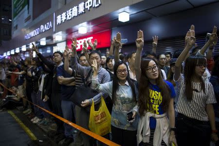 Pro-democracy protesters imitate a three-finger salute from the movie "The Hunger Games", at Mong Kok shopping district in Hong Kong November 28, 2014. REUTERS/Tyrone Siu