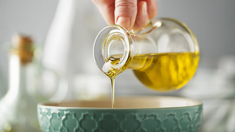 pouring olive oil into bowl