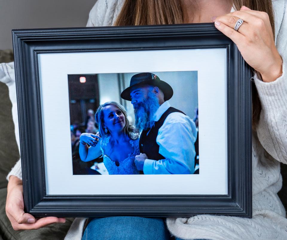 Megan Kolb holds her favorite photo of her and her father on her wedding day.