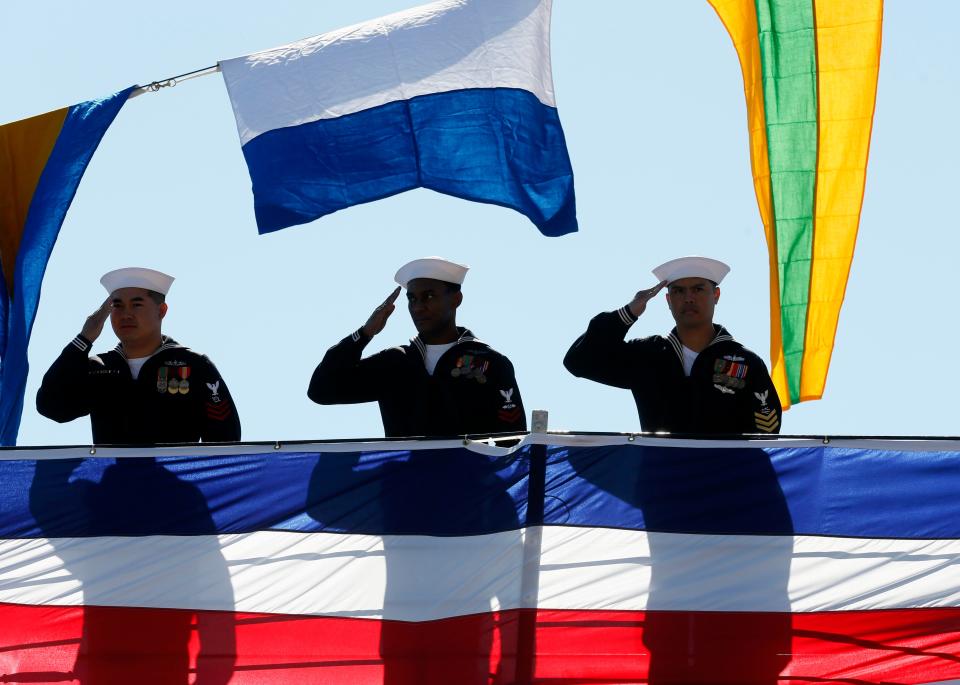 Sailors from the USS Detroit salute during the commissioning ceremonies of the USS Detroit in front of the Renaissance Center in Detroit, Michigan on October 22, 2016.