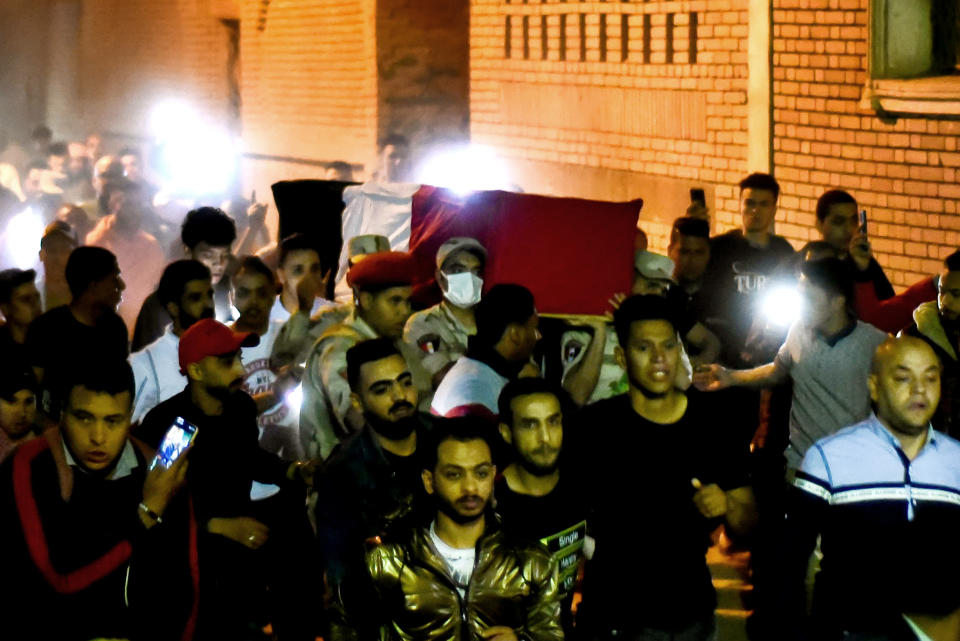 Men carry the coffin of military solider Ahmed Mohamed Ahmed Ali, who was killed in battle, during his funeral service, in Qalyubia province, Egypt, Sunday, May 8, 2022. At least 11 Egyptian troops, including an officer, were killed Saturday, May 7, 2022 in a militant attack on a water pumping station east of the Suez Canal, the military said. (AP Photo/Sayed Hassan)