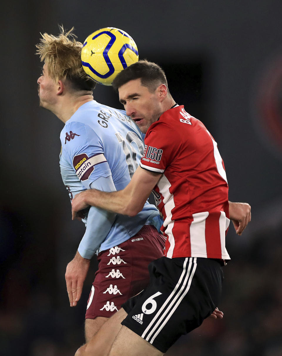 Aston Villa's Jack Grealish, left and Sheffield United's Chris Basham battle for the ball during the English Premier League soccer match between Sheffield United and Aston Villa, at Bramall Lane, in Sheffield, England, Saturday, Dec. 14, 2019. (Mike Egerton/PA via AP)